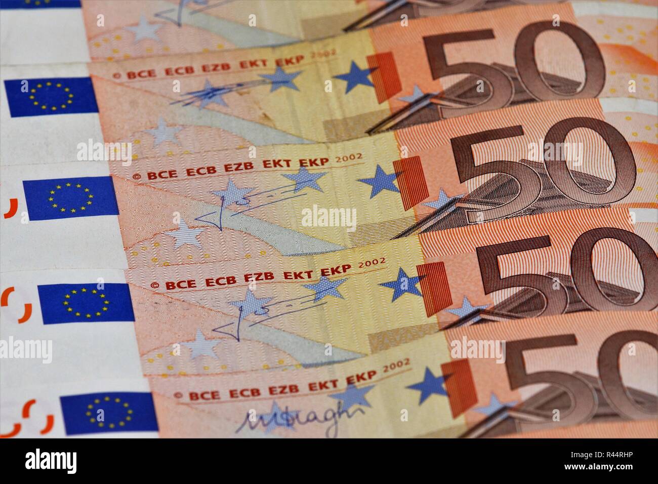 several 50 euro bills are superimposed in a row Stock Photo