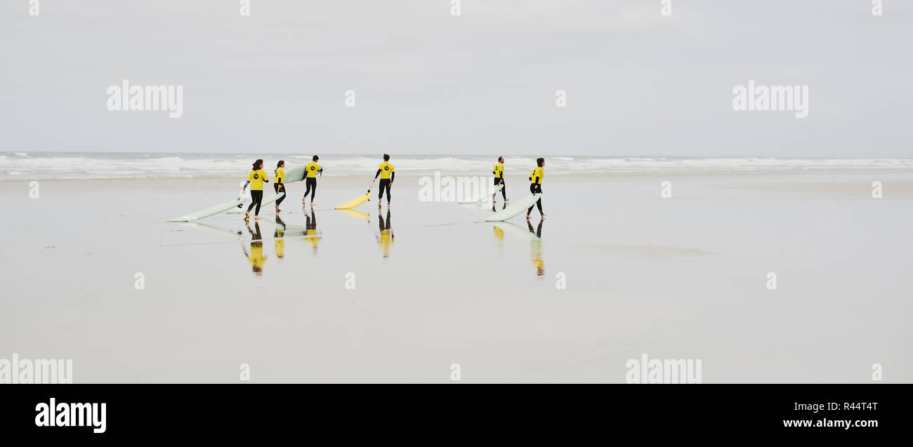 Surf School on an empty large sandy beach Stock Photo