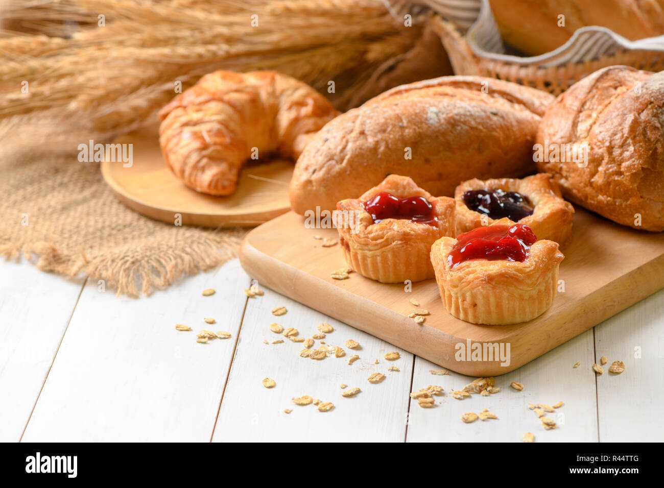 Homemade Danish bread with fruits, cherry sauce on white wood  background, breakfast food concept Stock Photo