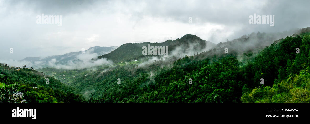 clouds floating over the mountain range as seen while driving to Binsar, near Almora, Uttarakhand,. rainy season, monsoon India Stock Photo
