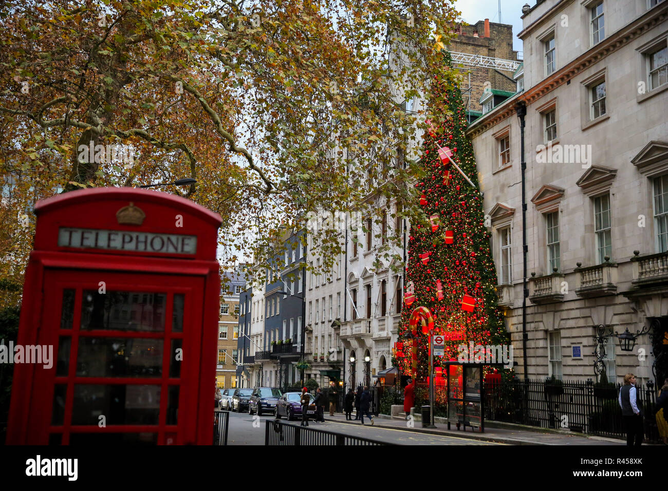 London, UK 25 Nov 2108 - A Christmas tree decorated with presents and  lights outside Annabel's Ð