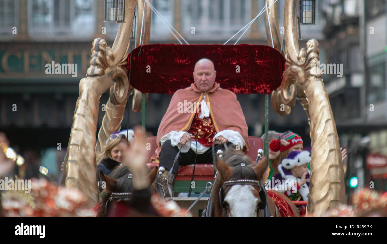 Glasgow, Scotland, UK. 25th November, 2018. The annual Style Mile Carnival has paraded through Glasgow city centre from St. Enoch Square to George Square, where the Christmas market was opened this afternoon. Watched by thousands of locals and tourists, hundreds of festive performers in dazzling costumes took to the streets of Scotland's largest city. The procession was led by Lord Provost Eva Bolander, along with 8-year-old Caleb Miller, who is raising funds for Glasgow Children's Hospital Charity. Iain McGuinness / Alamy Live News Stock Photo