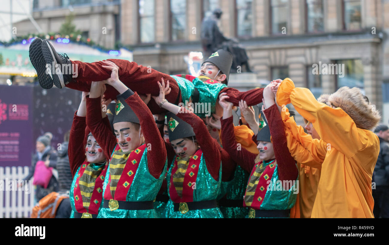 Glasgow, Scotland, UK. 25th November, 2018. The annual Style Mile Carnival has paraded through Glasgow city centre from St. Enoch Square to George Square, where the Christmas market was opened this afternoon. Watched by thousands of locals and tourists, hundreds of festive performers in dazzling costumes took to the streets of Scotland's largest city. The procession was led by Lord Provost Eva Bolander, along with 8-year-old Caleb Miller, who is raising funds for Glasgow Children's Hospital Charity. Iain McGuinness / Alamy Live News Stock Photo