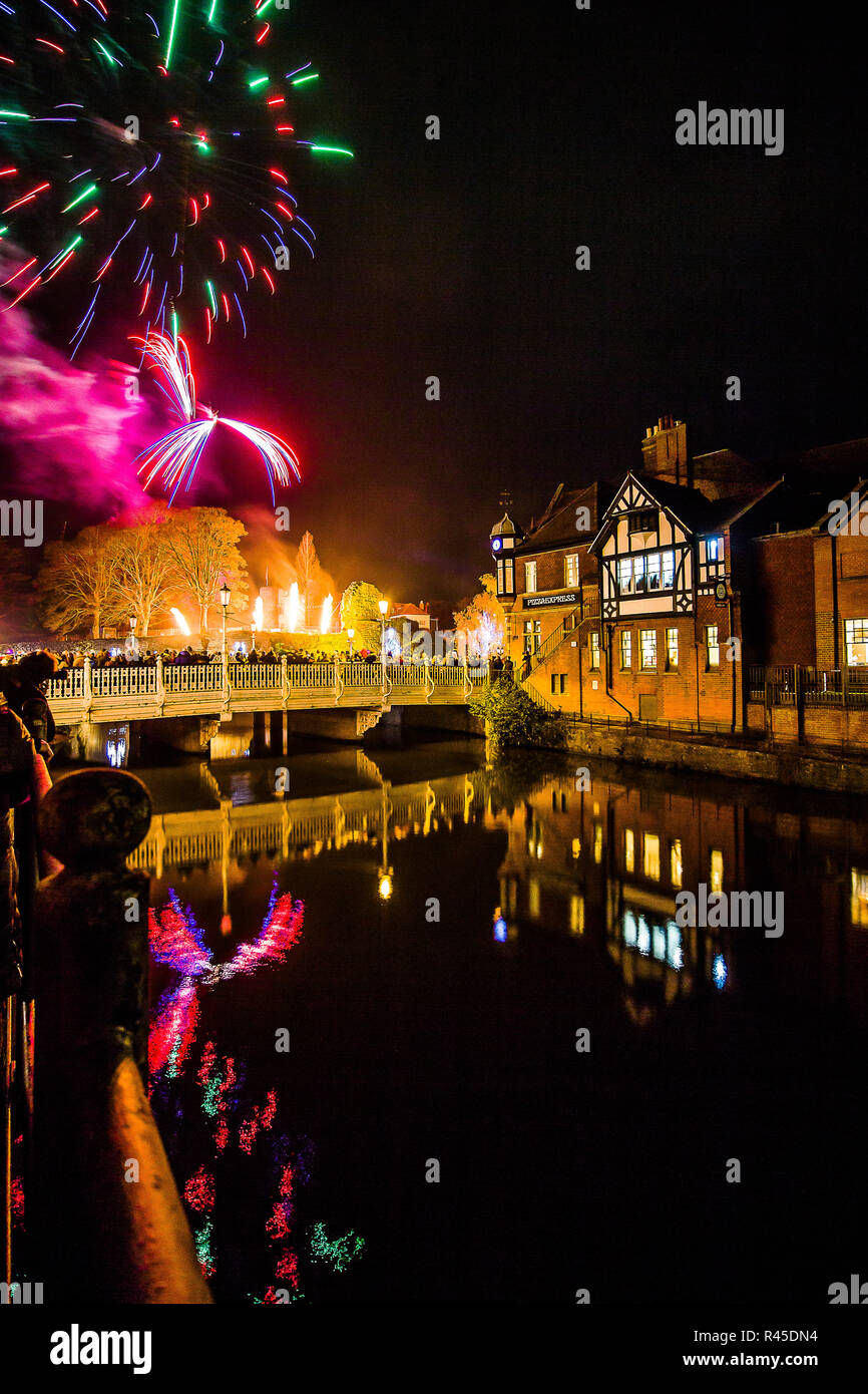 Tonbridge, Kent, England. 25 November 2018. The firework show in front of Tonbridge Castle lawn to mark the switch on of the Tonbridge Chirstmas lights. Photo taken adjacent to the river Medway with Tonbridge Castle in the distance, light up at night. Sarah Mott / Alamy Live News Stock Photo