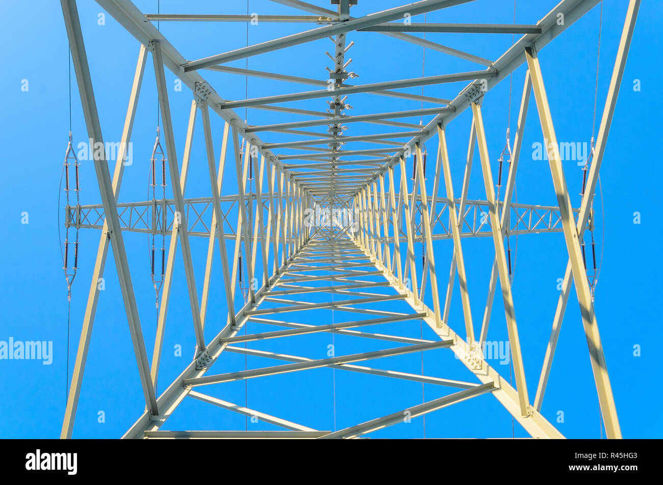 Symmetrical Pylon upwards against blue winter sky Stock Photo - Alamy
