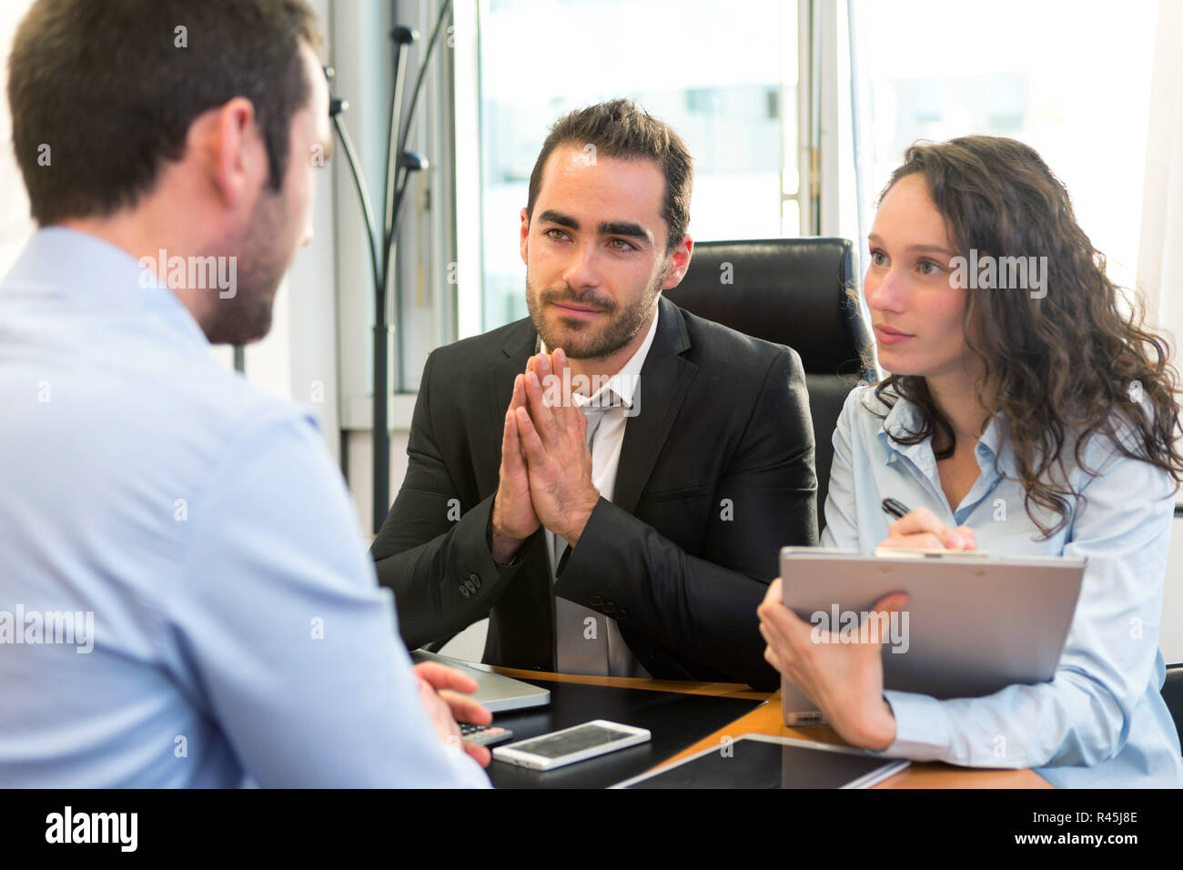 Attractive boss doing interview with his assistant Stock Photo - Alamy