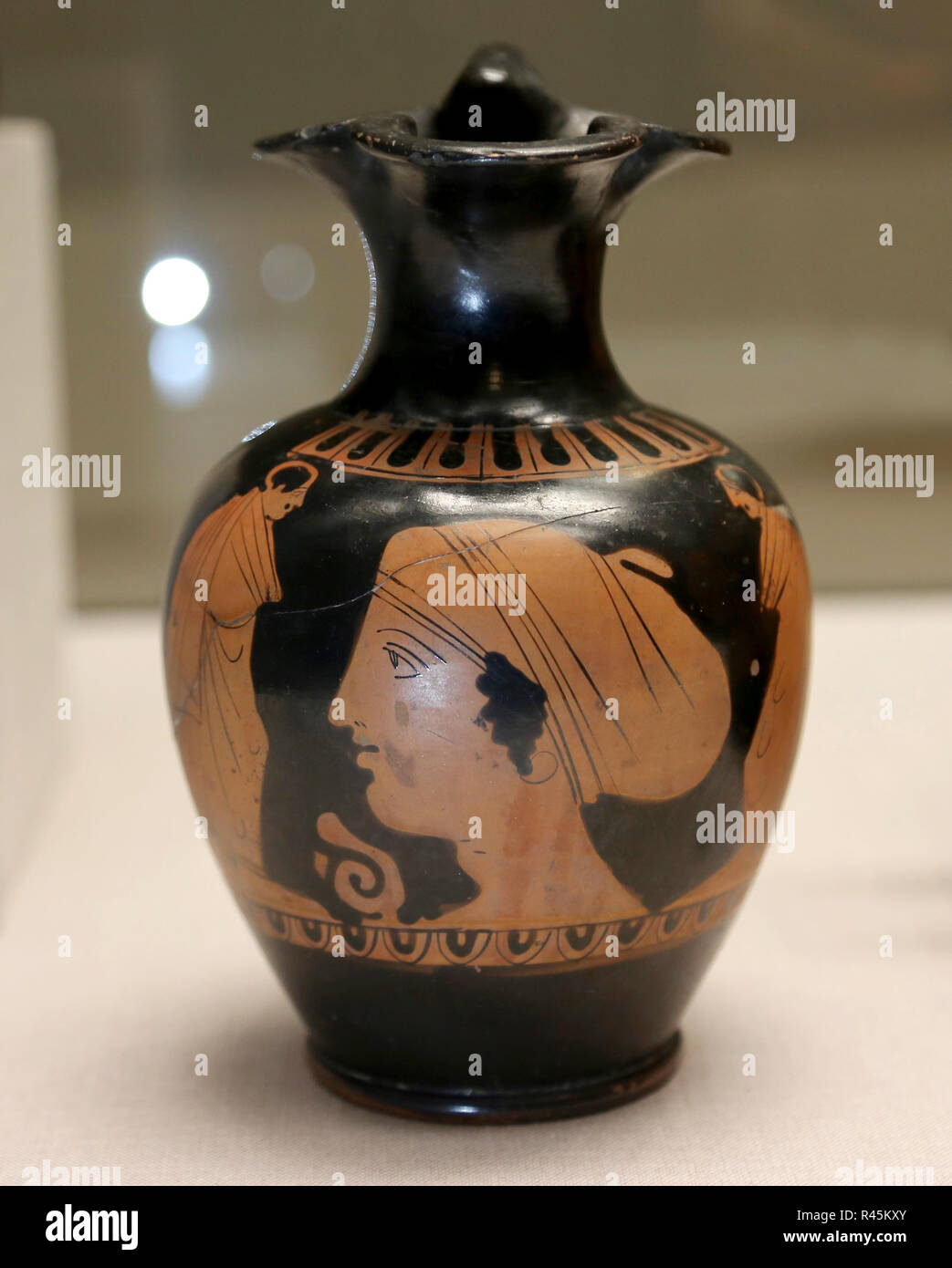 Attic red-figure pottery, ceramic vase with a woman face. 6th century  to 4th century BC. Greek Culture. Stock Photo