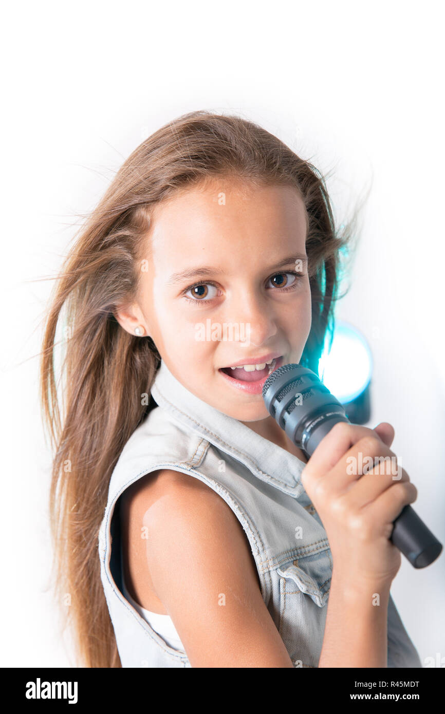 Young girl singing with microphone Stock Photo - Alamy