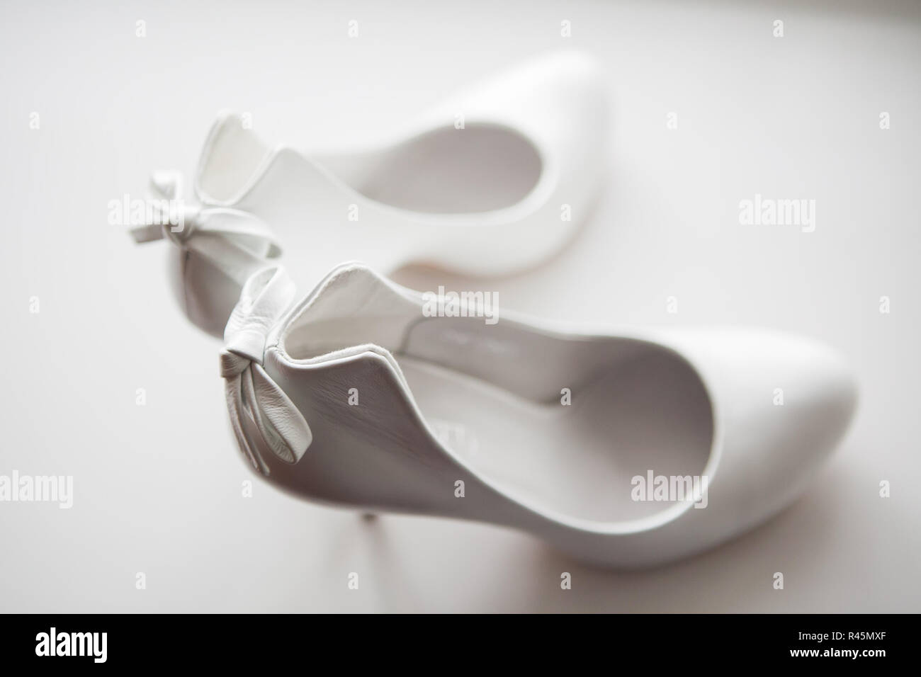 Gorgeous wedding shoes in heels on a white background Stock Photo - Alamy