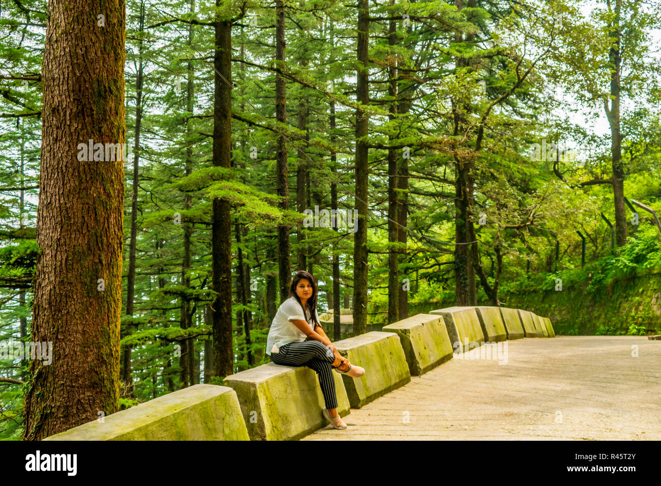 A lady by the side of the mountain road, Landour Stock Photo
