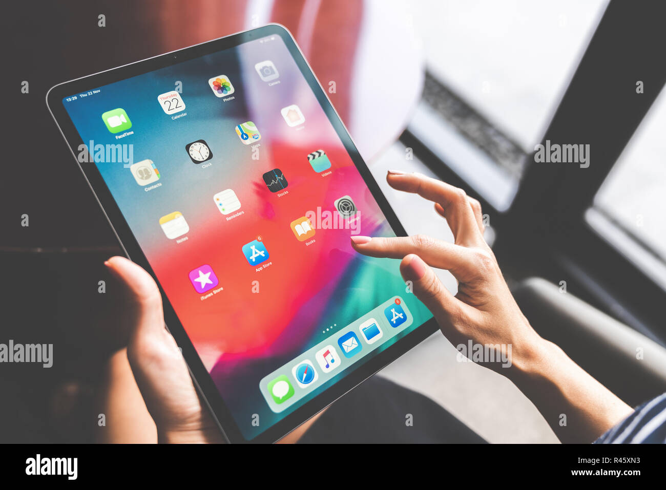 Bangkok, Thailand - Nov 22, 2018: Asian woman using the new 11 inch Apple iPad pro 2018, swiping home screen or touching app icon Stock Photo