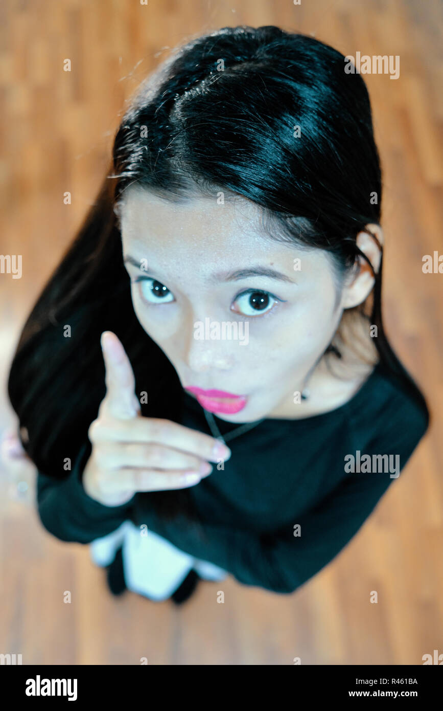 Beautiful woman posing - look up, facial expression, pointing, shocked Stock Photo