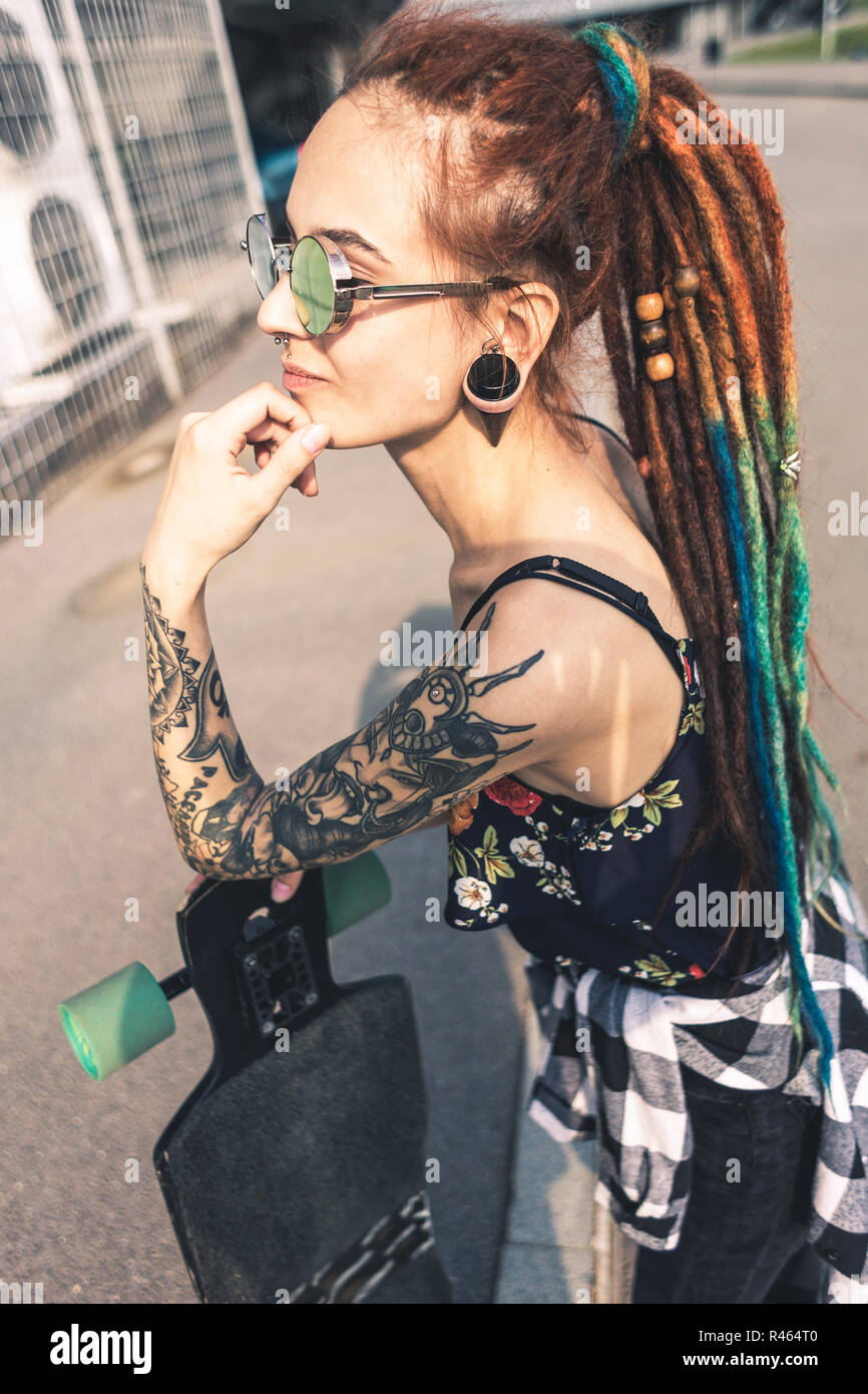 Young Girl With Tattoo And Dreadlocks On Urban Industrial Background Stock Photo Alamy