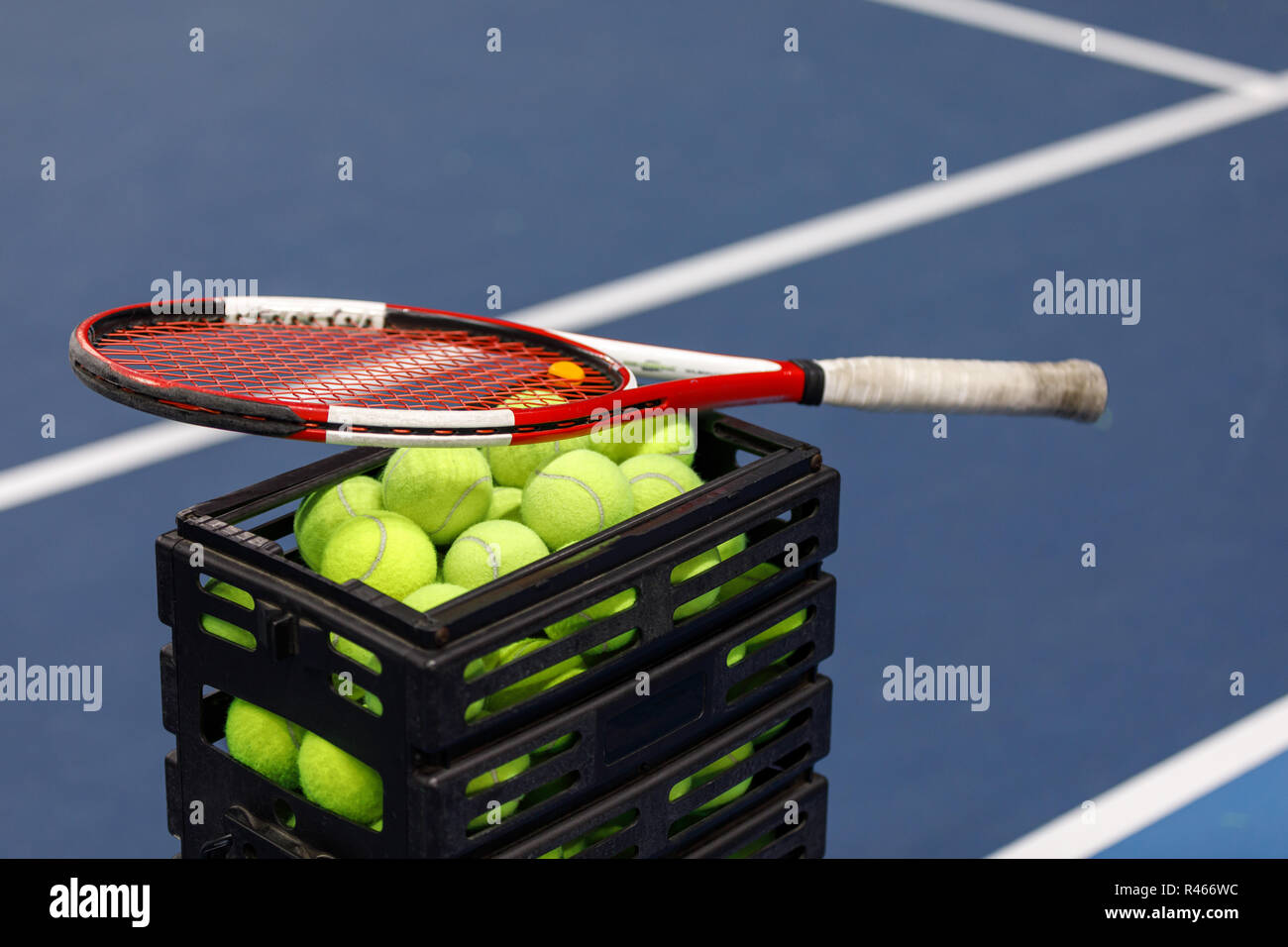 Box with tennis balls and tennis racket on tennis court Stock Photo Alamy