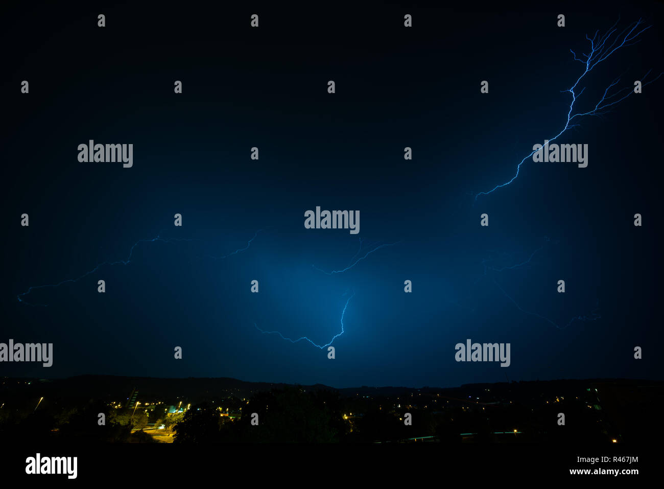 Lightning strike on a dark blue sky. bolt of light cutting night sky ...