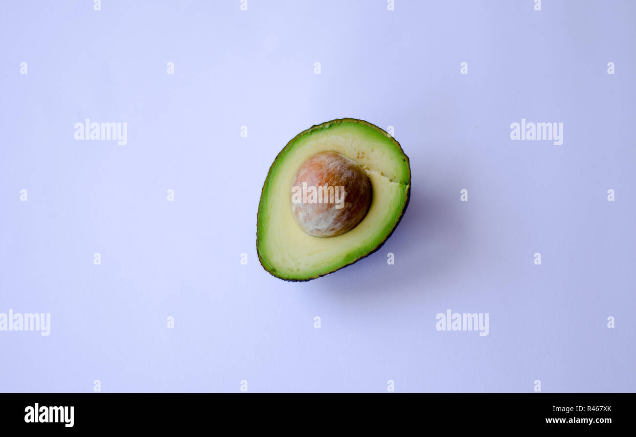 An halved 'Hass' avocado on white background Stock Photo