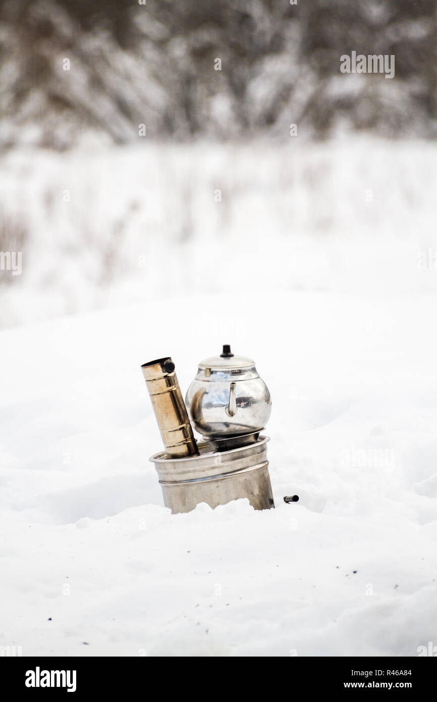 Portable Stove in a Picnic Field Covered with Snow Stock Photo