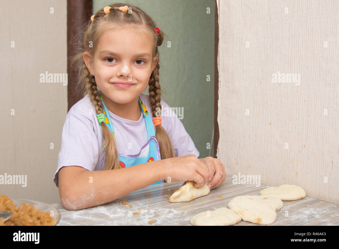 Cheerful girl sculpts cakes with cabbage Stock Photo