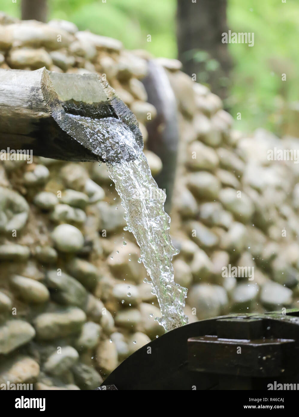 water flows from a pipe or water gushing out of the pipe close up Stock