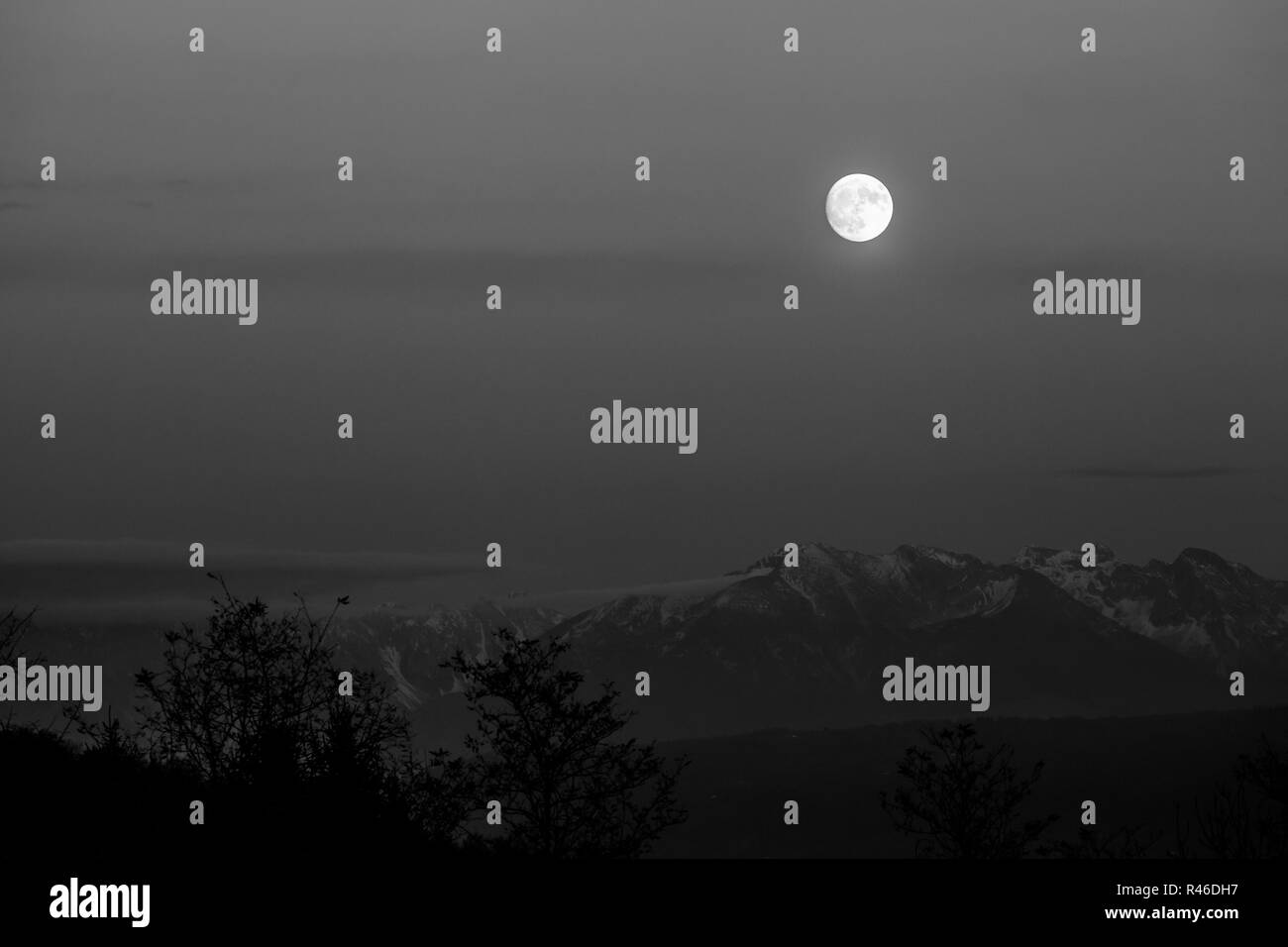 Full moon over the mountains black and white effect Stock Photo