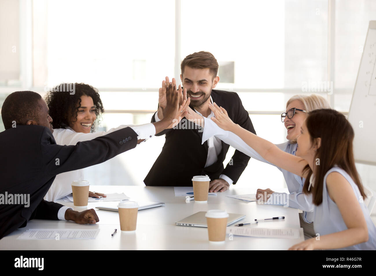 Happy motivated diverse business team people giving high five Stock ...