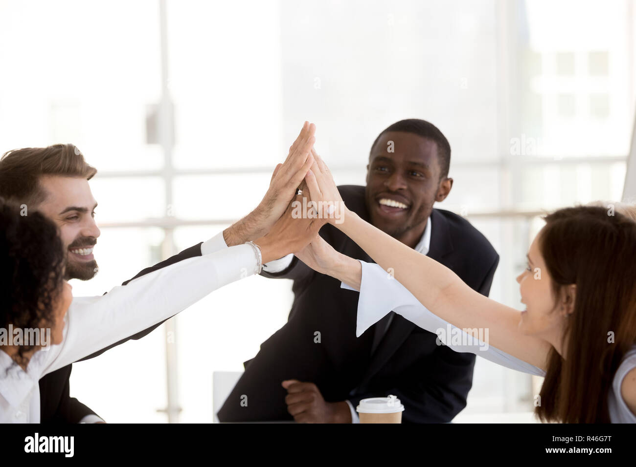 Happy african coach and diverse team people giving high five Stock ...