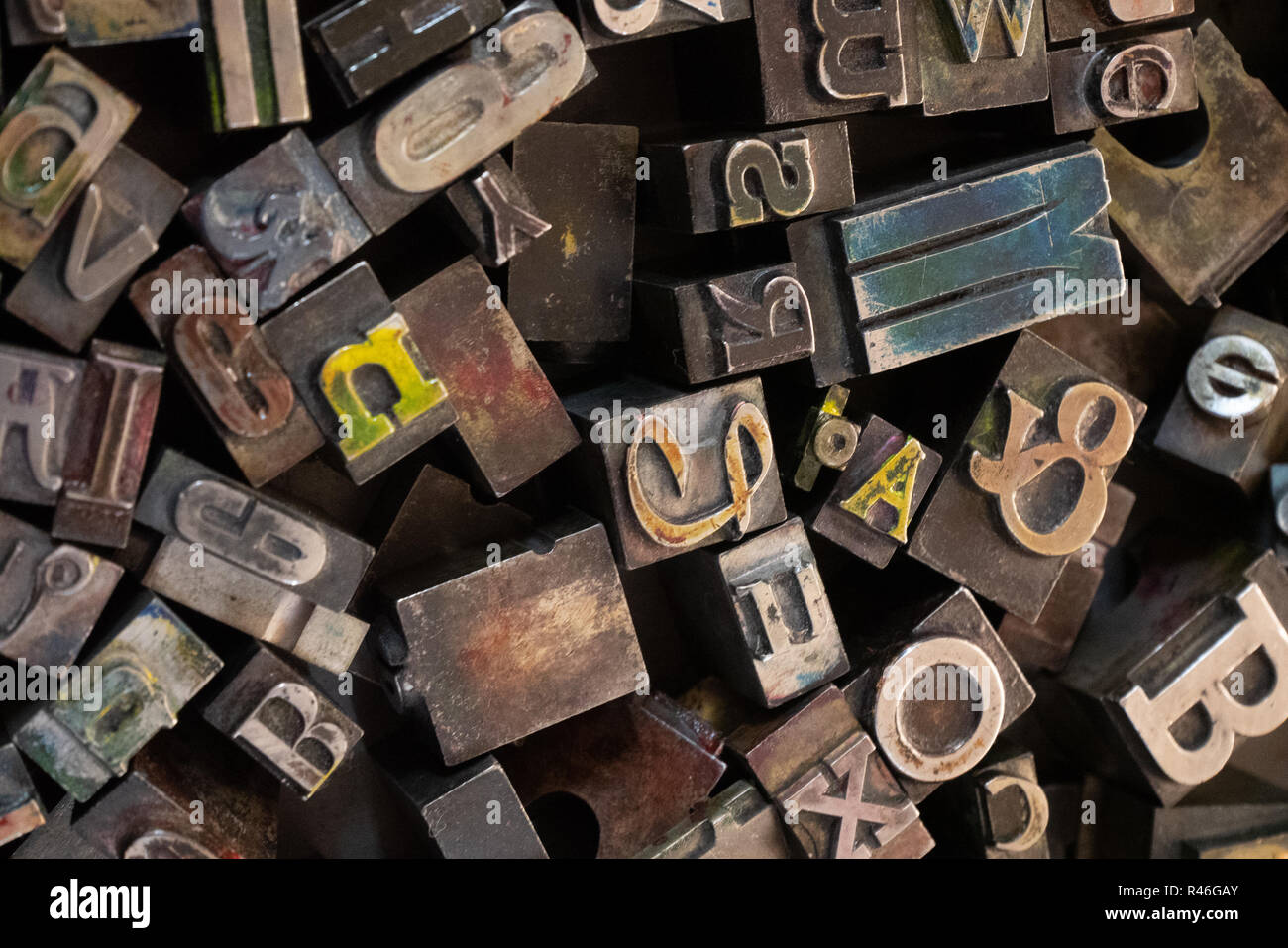 Jumble of different metal letters in a tray for use in an old Heidelberg printing press. Stock Photo