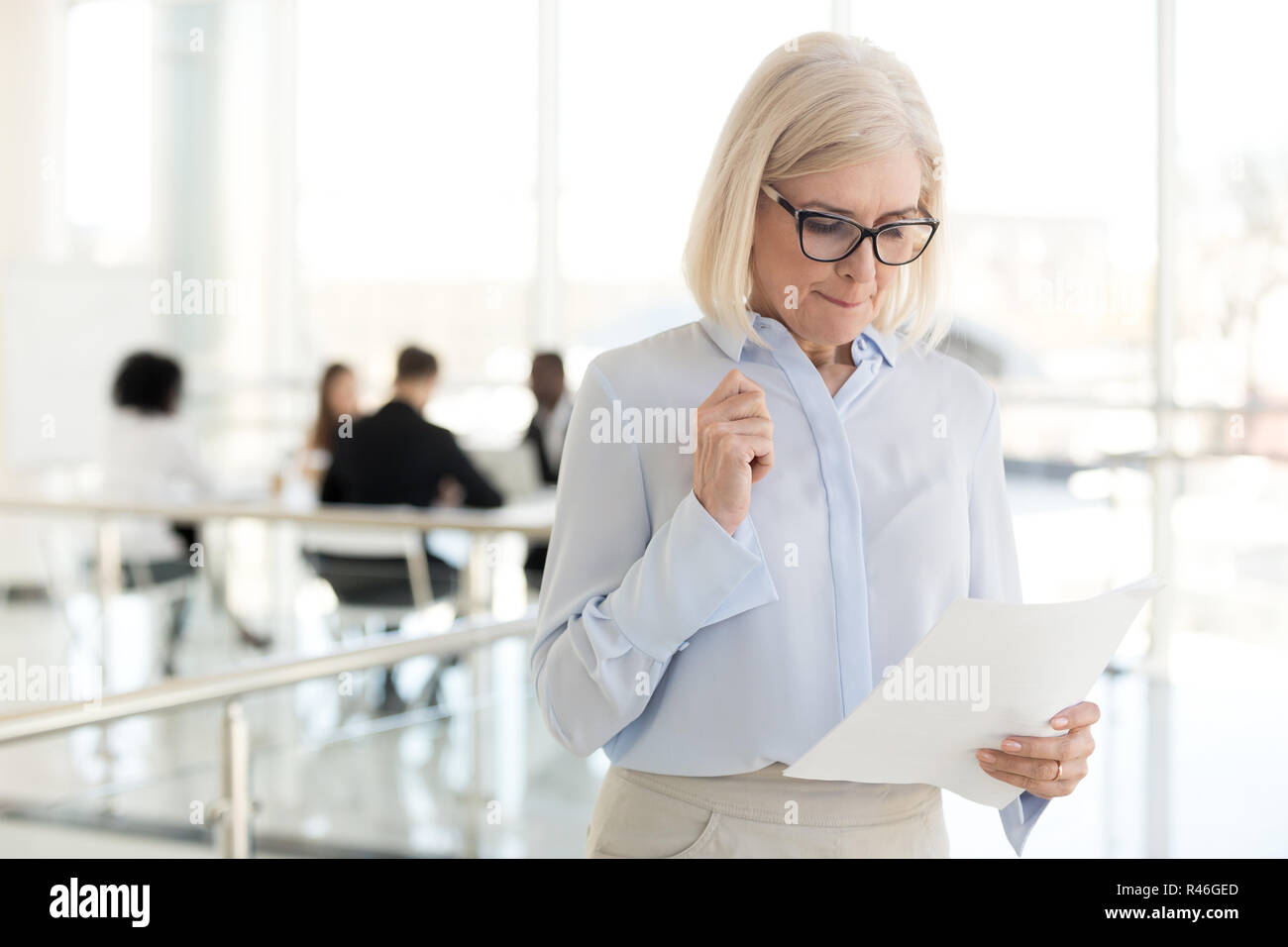 Nervous middle-aged businesswoman feeling stressed afraid waitin Stock Photo