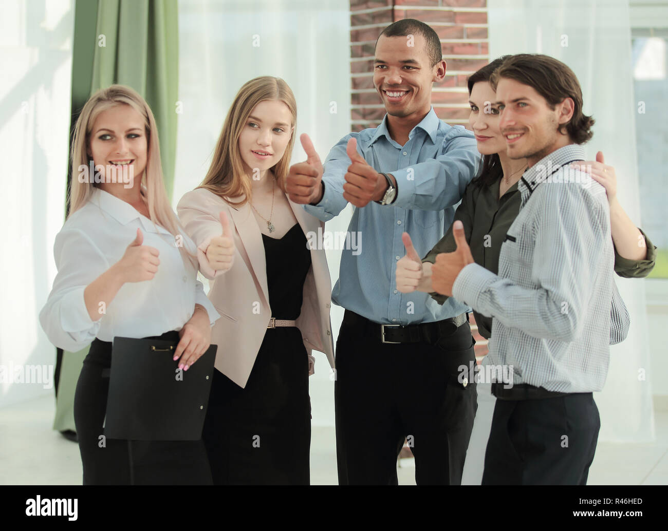 portrait of modern business team showing thumb up Stock Photo - Alamy