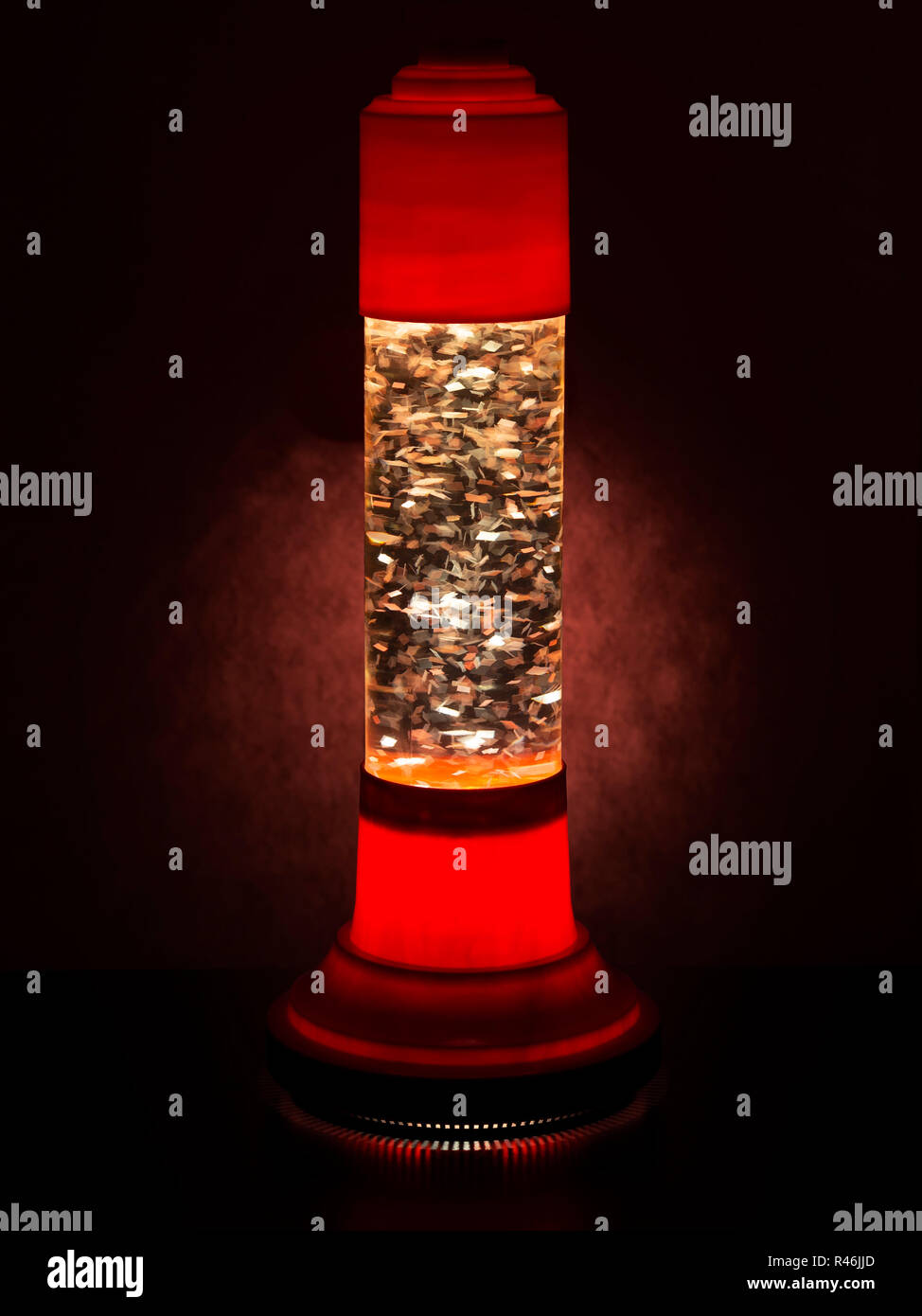 Glitter lava lamp with light behind. Genuine vintage 1970 edition, red orange colour. Stock Photo