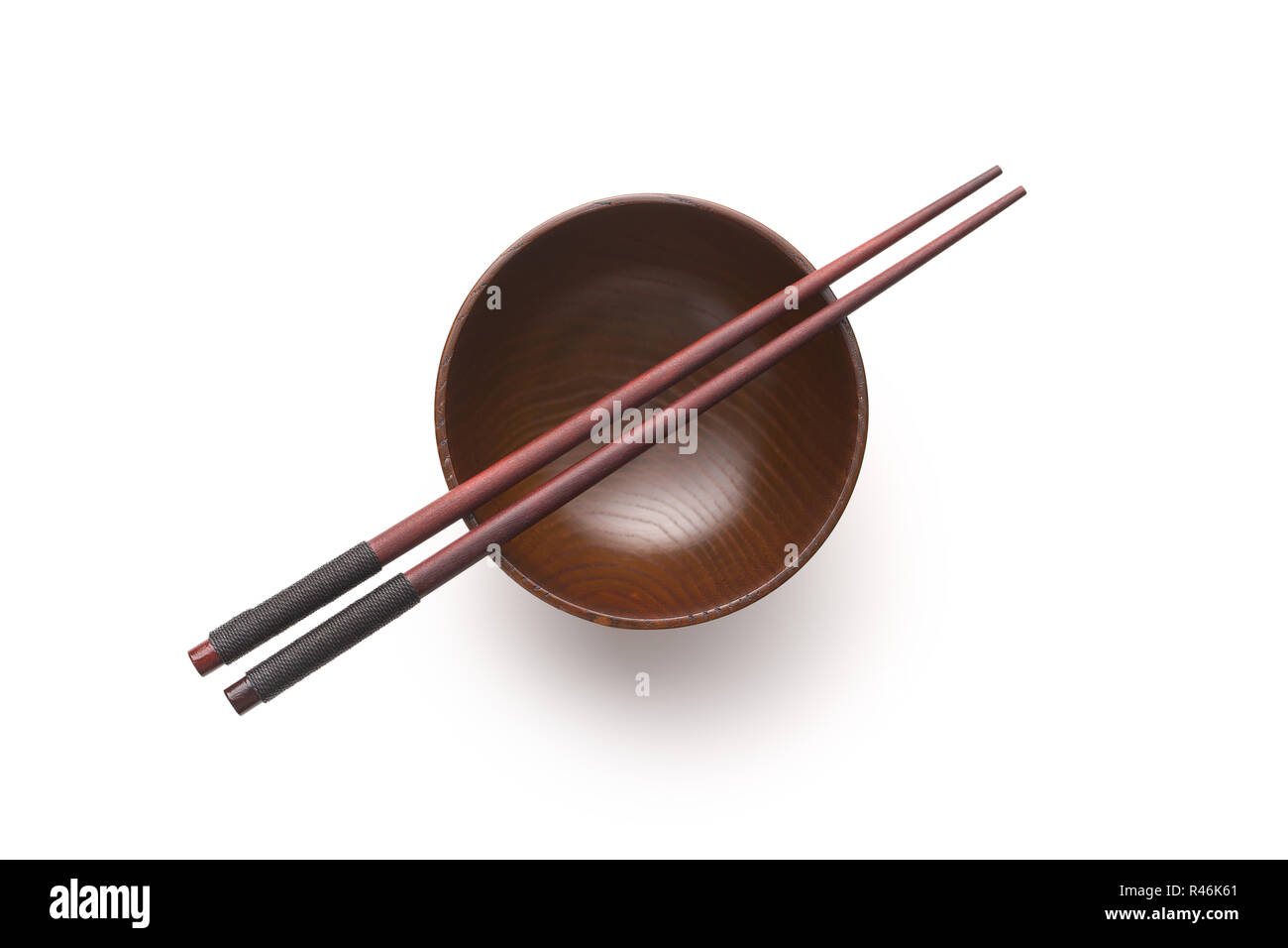 Wooden bowl and chopsticks isolated on white background. Stock Photo