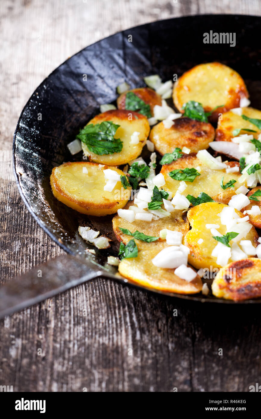 fried potatoes in an iron pan Stock Photo Alamy