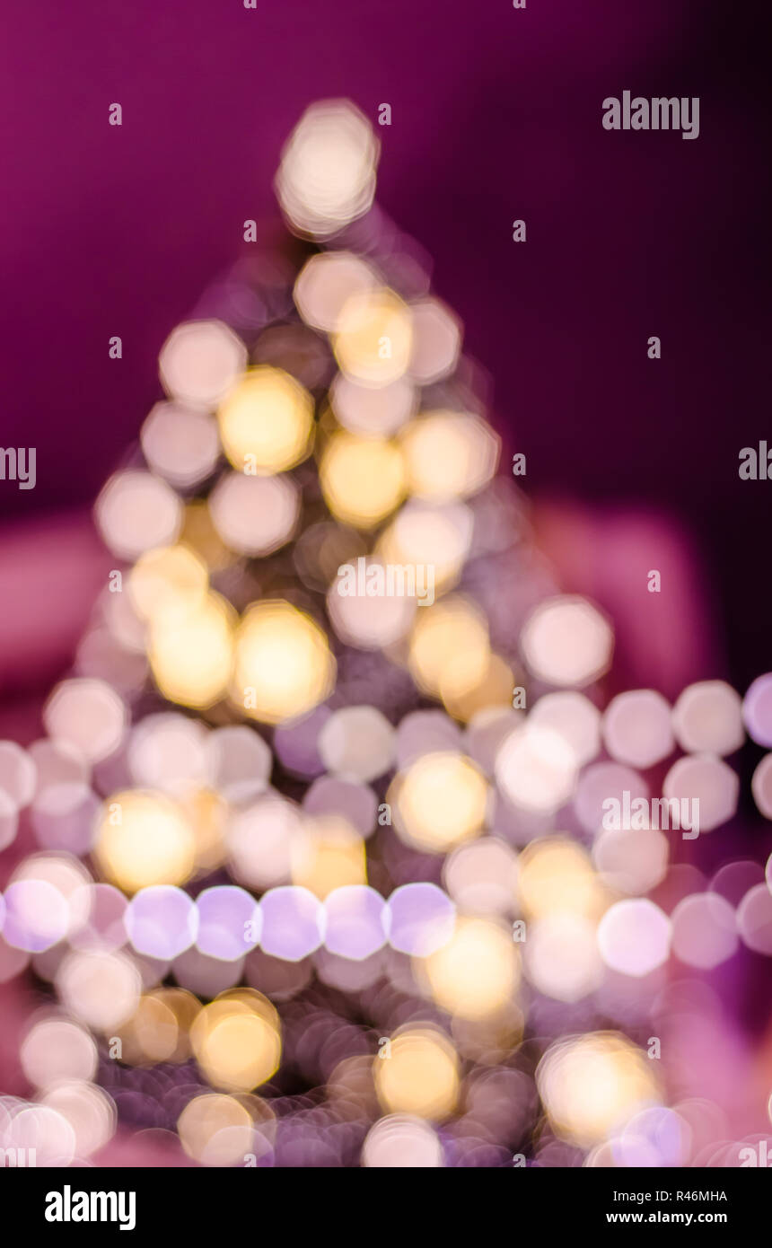 Decorated Christmas tree. Blurred lights background Stock Photo
