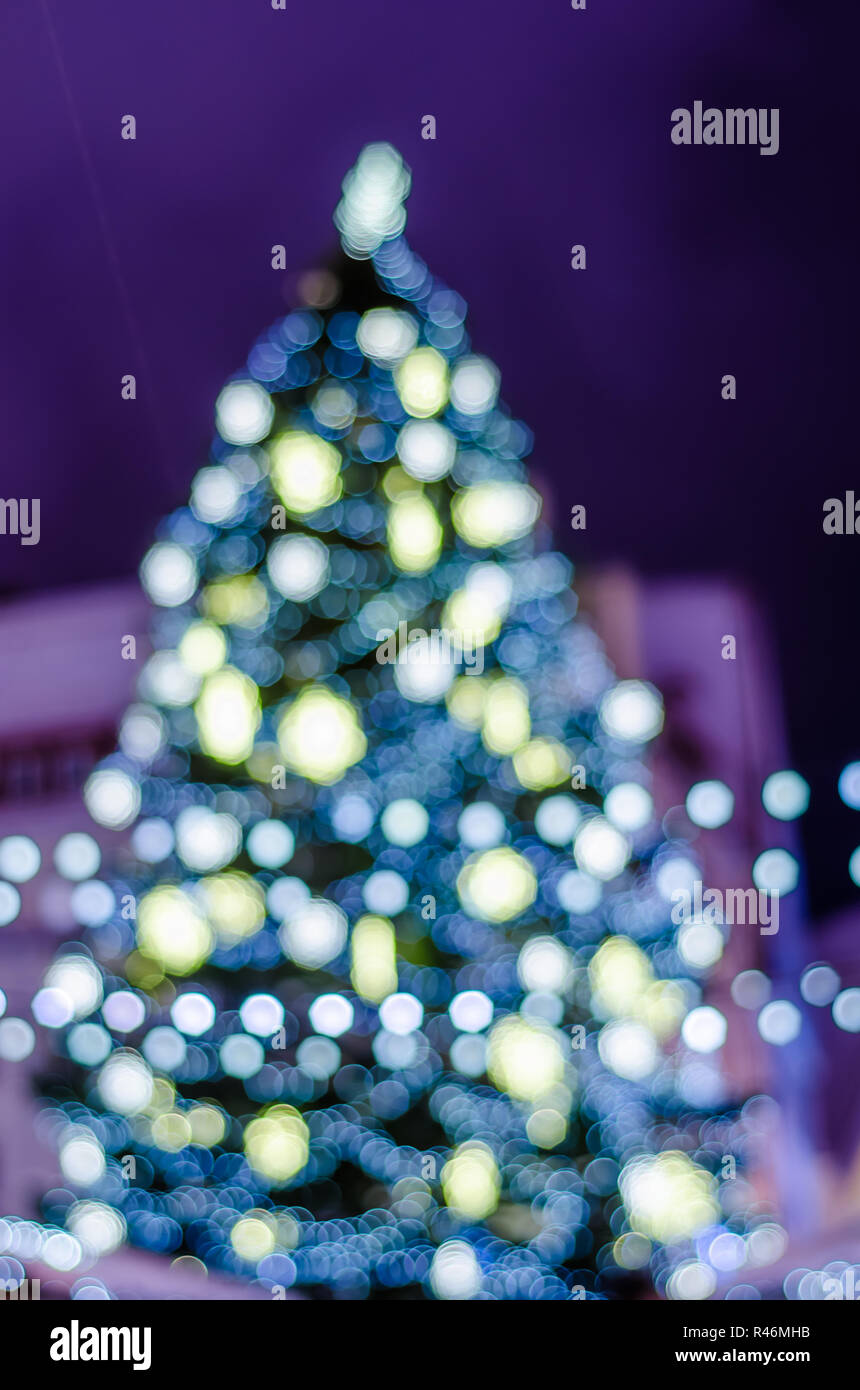 Decorated Christmas tree. Blurred lights background Stock Photo