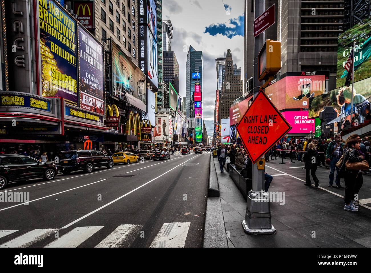 Times Square, Manhattan, New York, USA. October 13 2018. Looking down a New York Street with pedestrian crossing with cloudy sky on an autumn afternoon Stock Photo