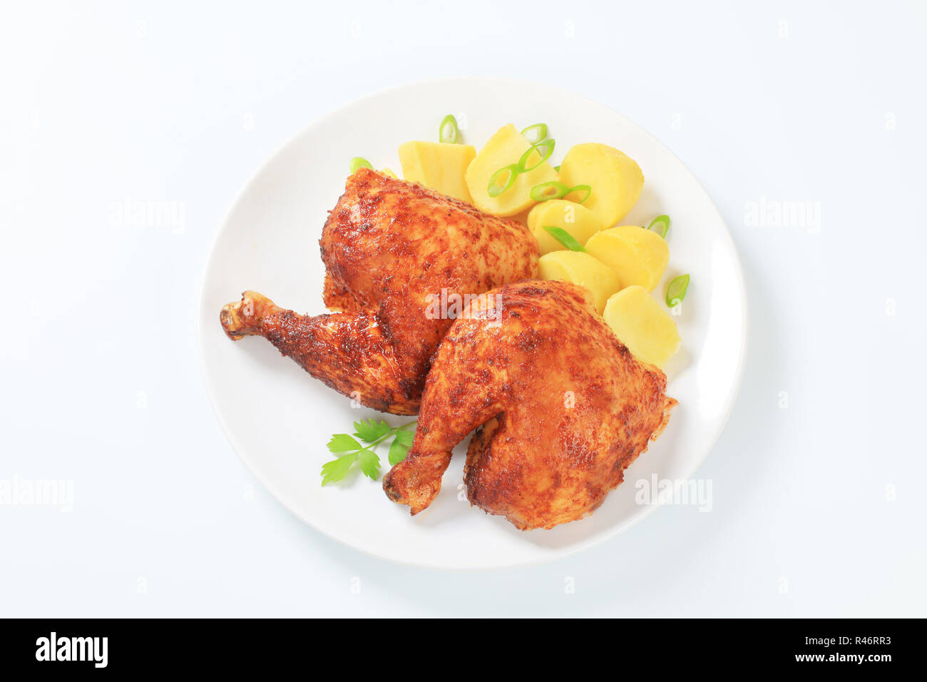 Garlic roasted chicken quarters with potatoes Stock Photo Alamy