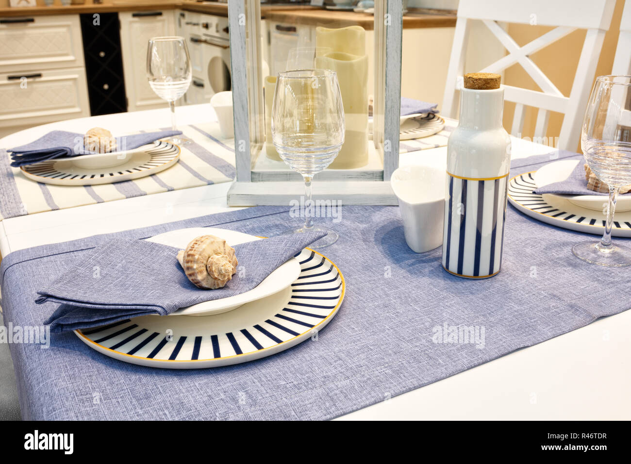 Served table with blue dishes on a blue white tablecloth Stock Photo