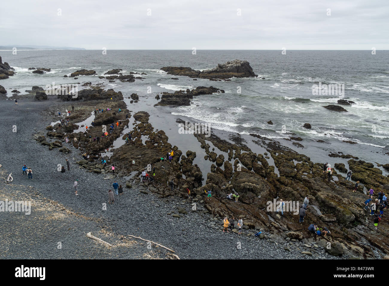 Cobble Beach with people enjoying the tide pools, Yaquina Head Outstanding Natural Area, Newport, Oregon Coast, USA. Stock Photo