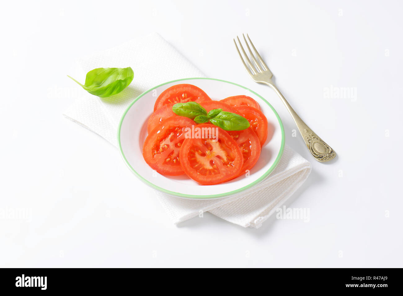 sliced tomato with basil Stock Photo - Alamy
