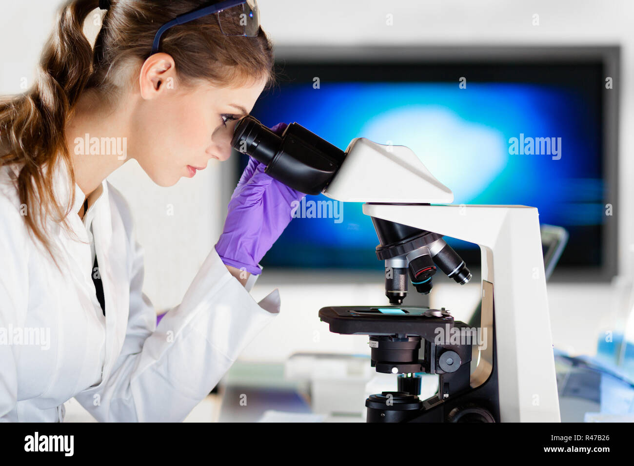 Portrait Of A Helth Care Professional Microscoping Stock Photo - Alamy