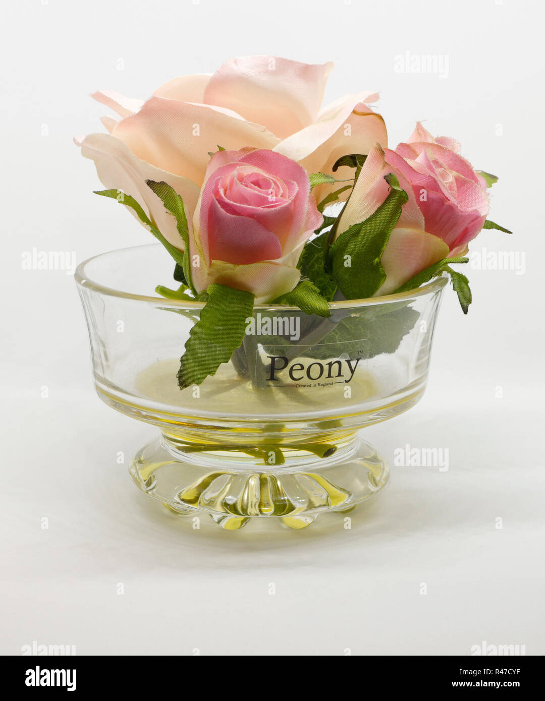 Artificial roses in glass bowl on white background Stock Photo