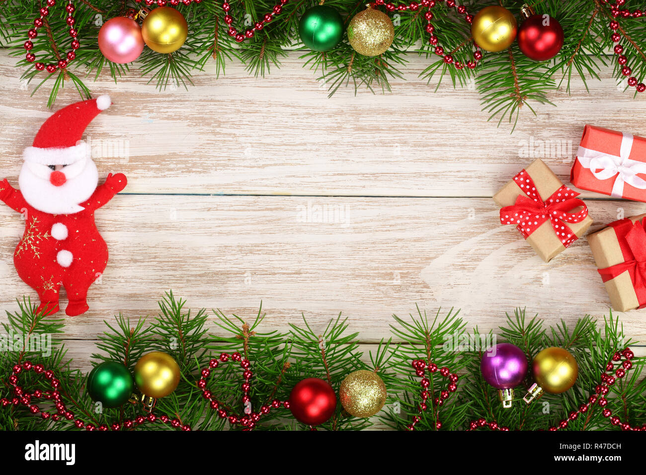 Christmas frame made of fir branches decorated with balls, Santa Claus ...