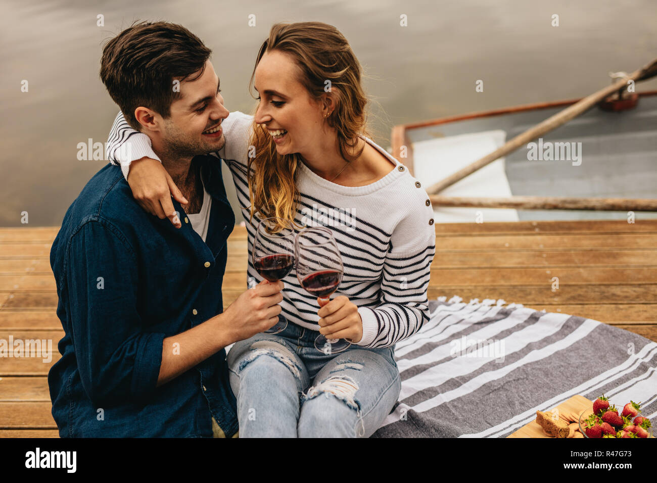 Couple sitting outdoors near a lake in a romantic mood – Jacob Lund  Photography Store- premium stock photo