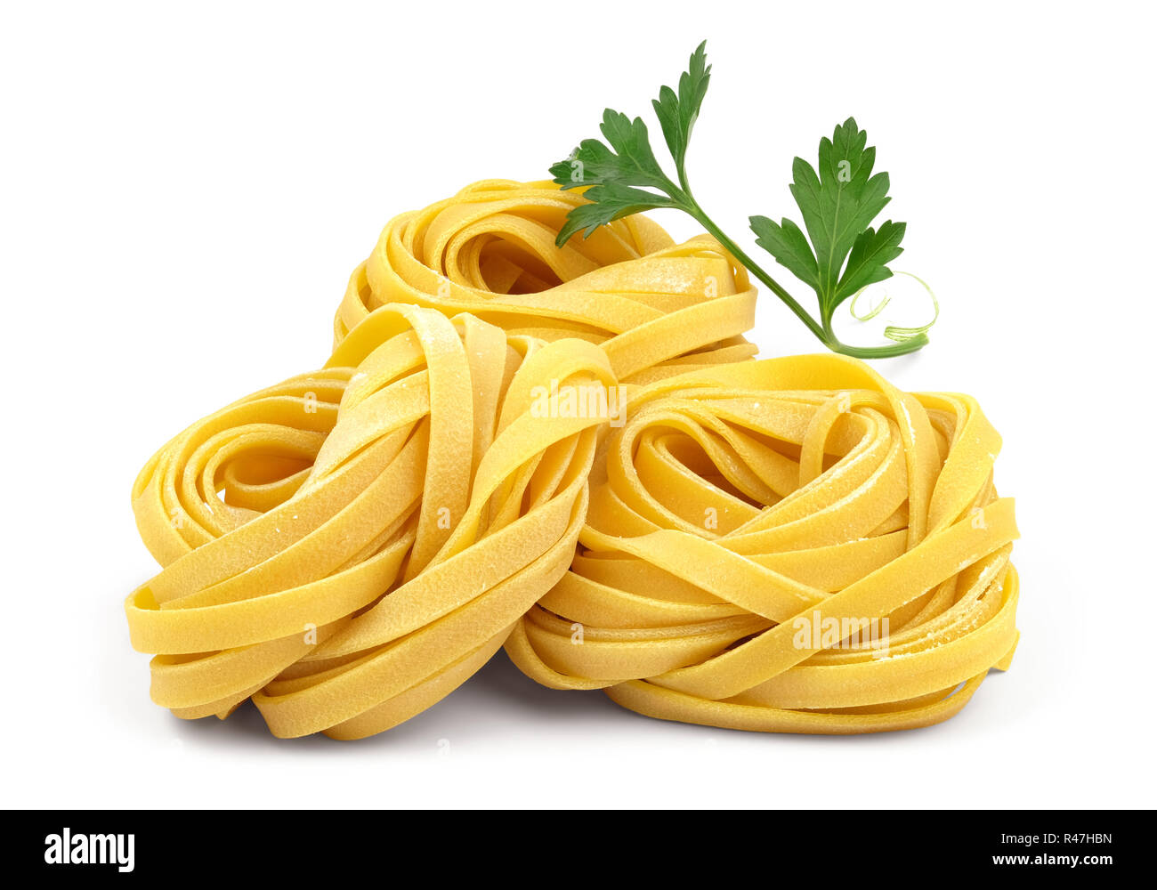 Italian rolled fresh fettuccine pasta with flour and parsley isolated