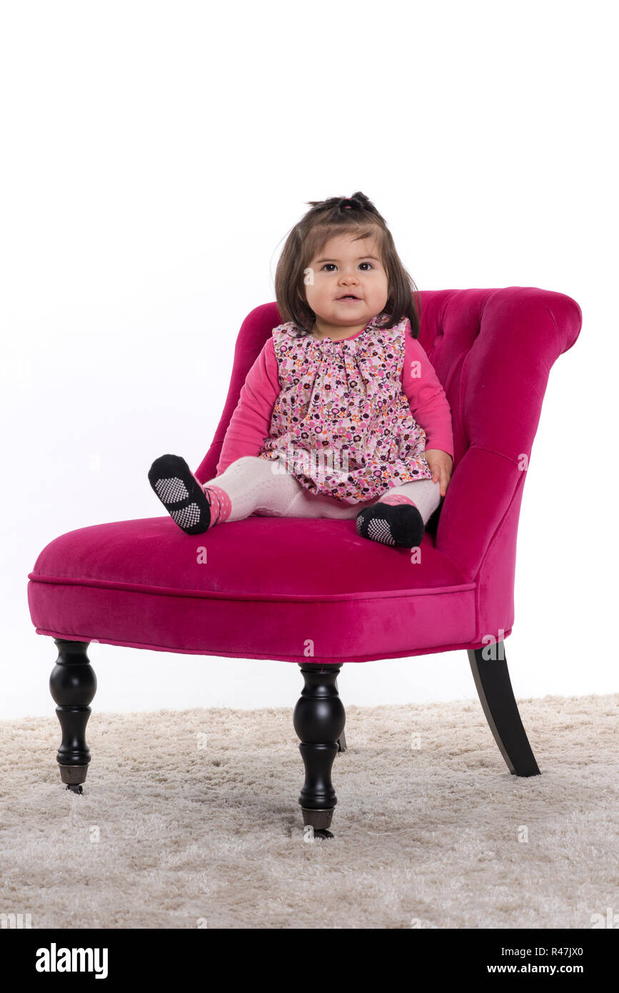 toddler sitting proudly on a chair Stock Photo