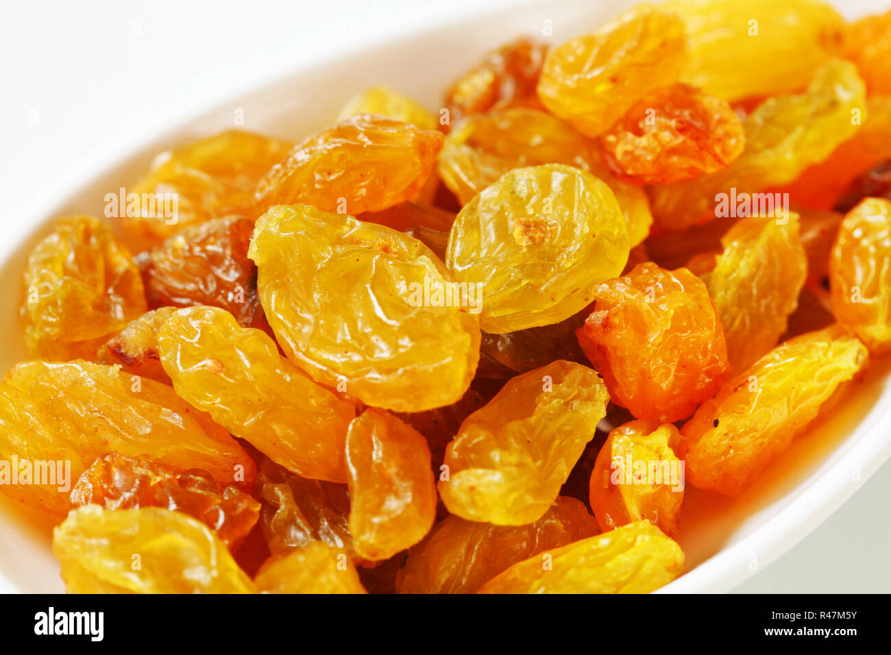 Goldencoloured dried grapes Stock Photo Alamy