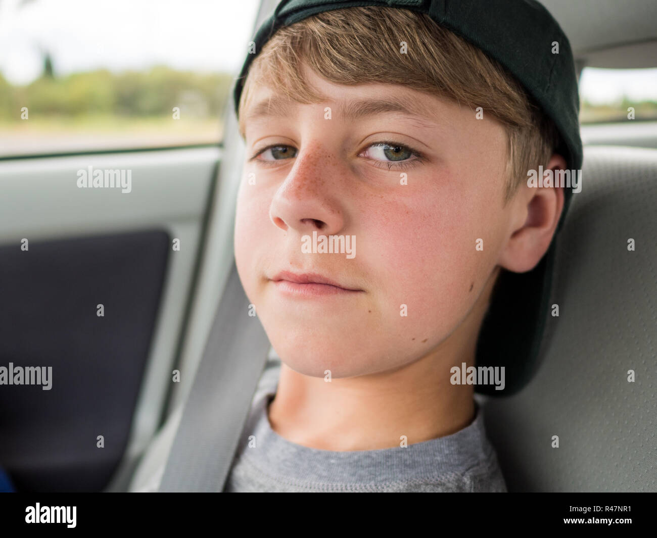 Close up portrait of casual teenage boy with backwards hat Stock Photo Alamy