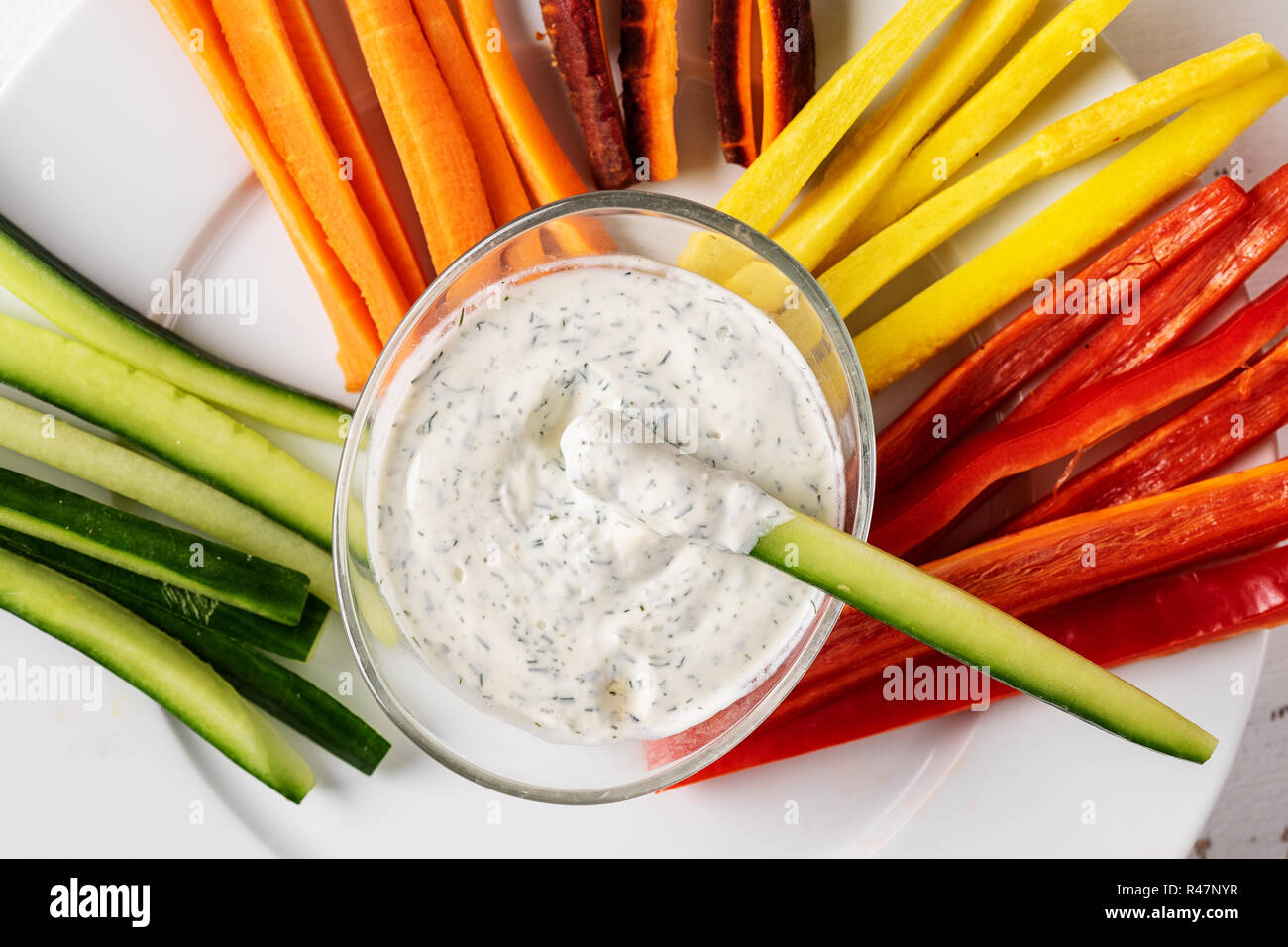 Close up of cream dip with coroful vegetable sticks. Stock Photo
