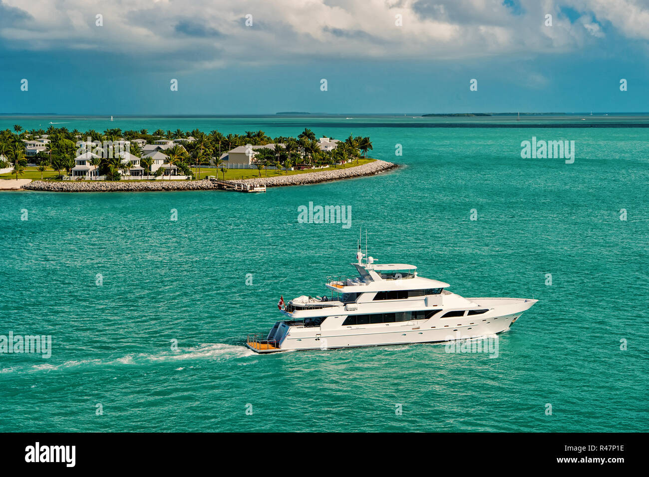 cruise touristic boats or yachts floating by island with houses and