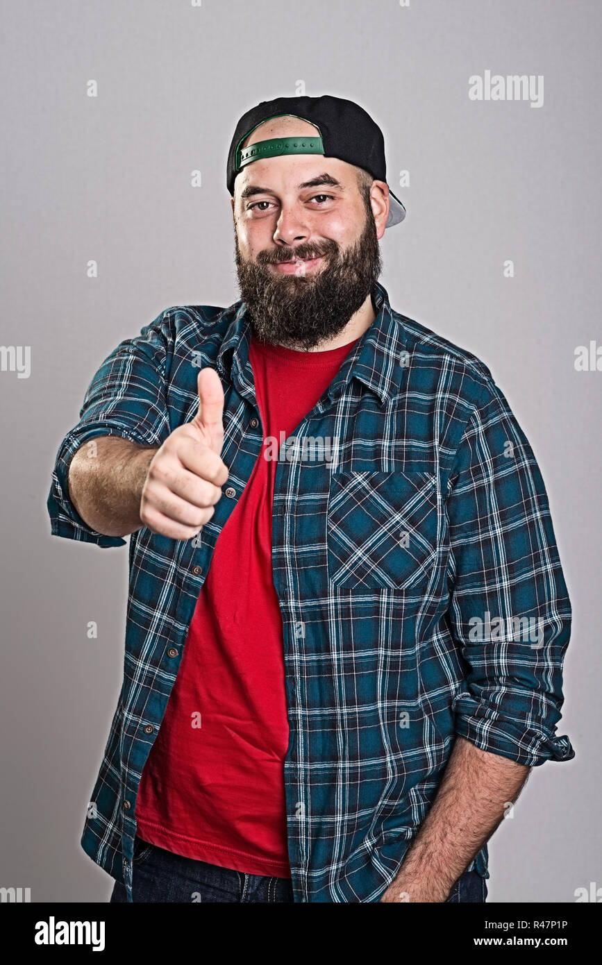 bearded man with baseball cap with thumb up Stock Photo